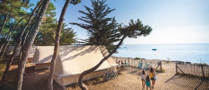Huttopia Village tent next to lakeside beach